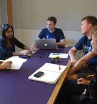 Students in a classroom around a table